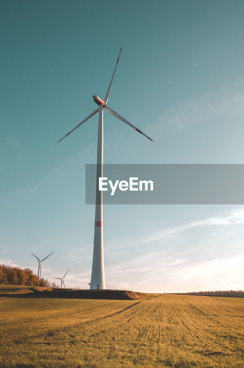 Windmill on field against sky