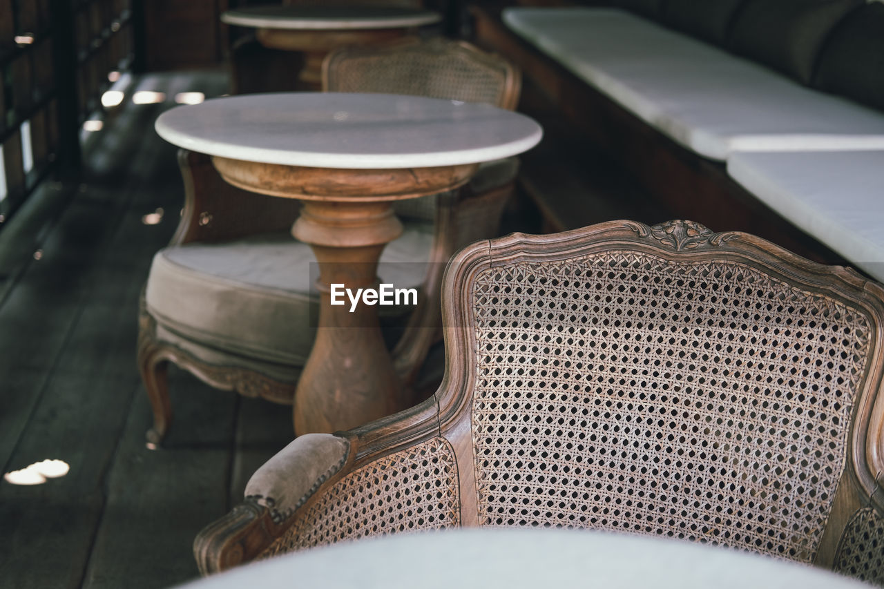 High angle view of empty chairs and table in cafe