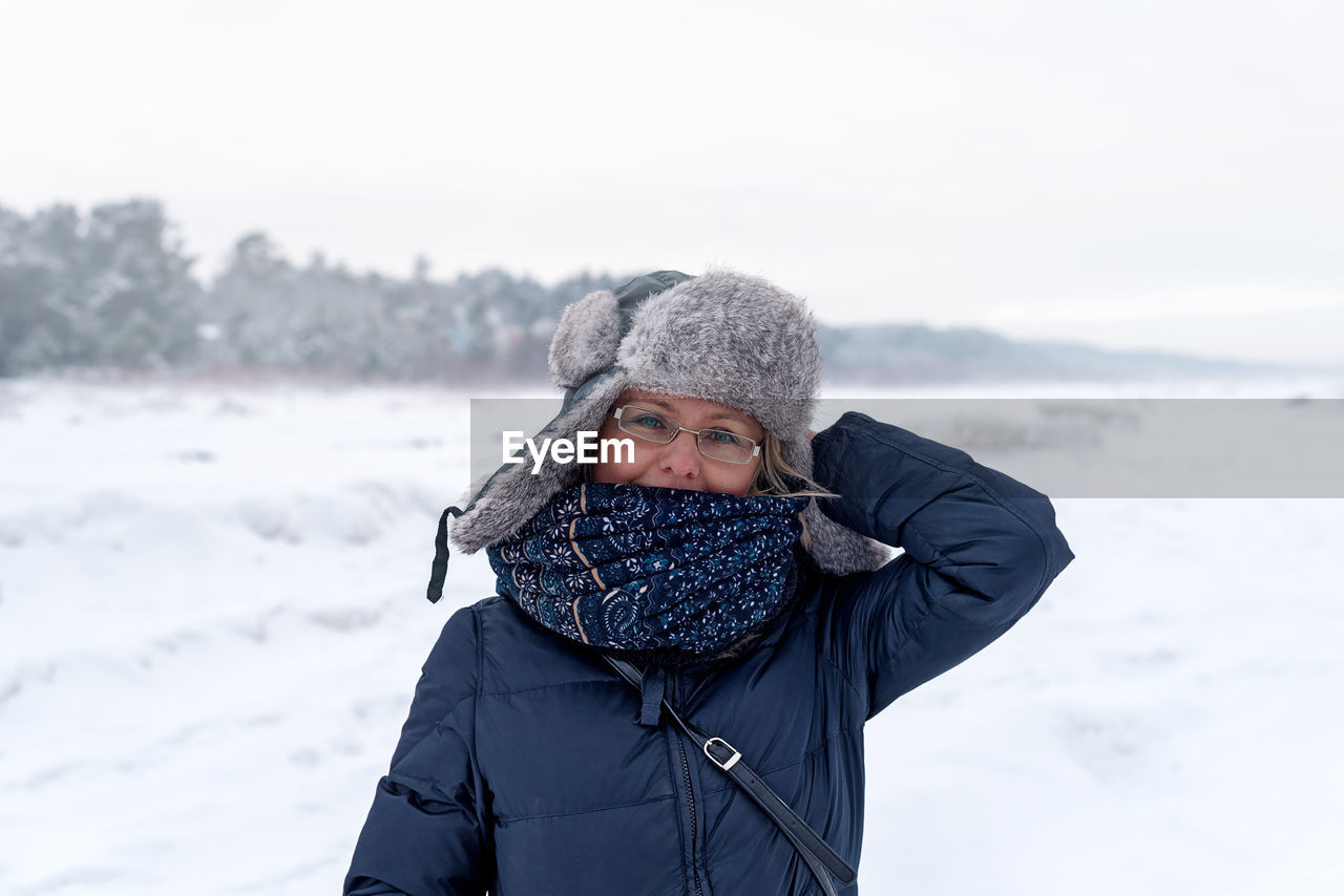 Smiling woman on the background of winter landscape, jurmala, latvia. 