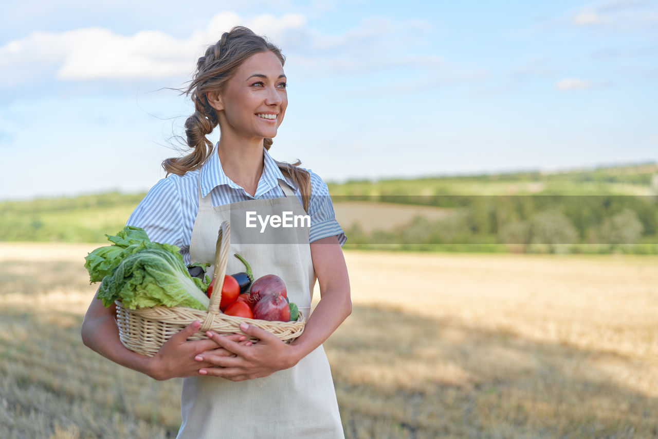 HAPPY WOMAN HOLDING ICE CREAM IN BASKET