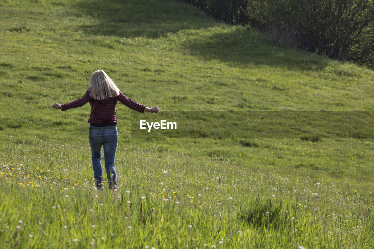 Rear view of woman in field