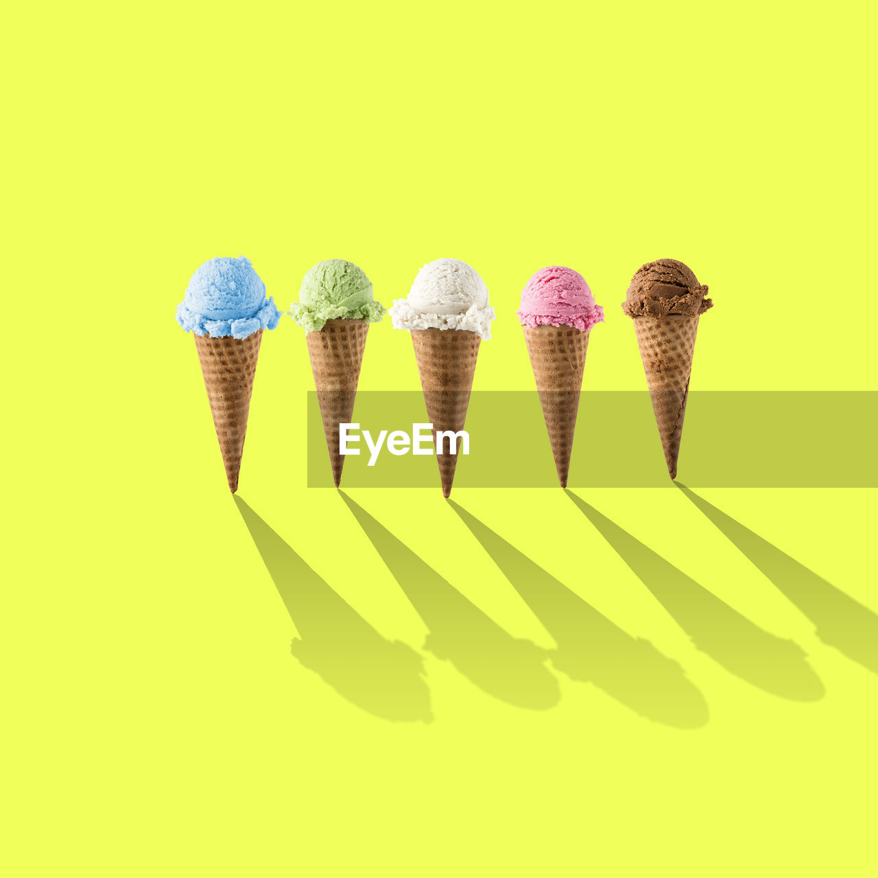 Ice cream cones over yellow background