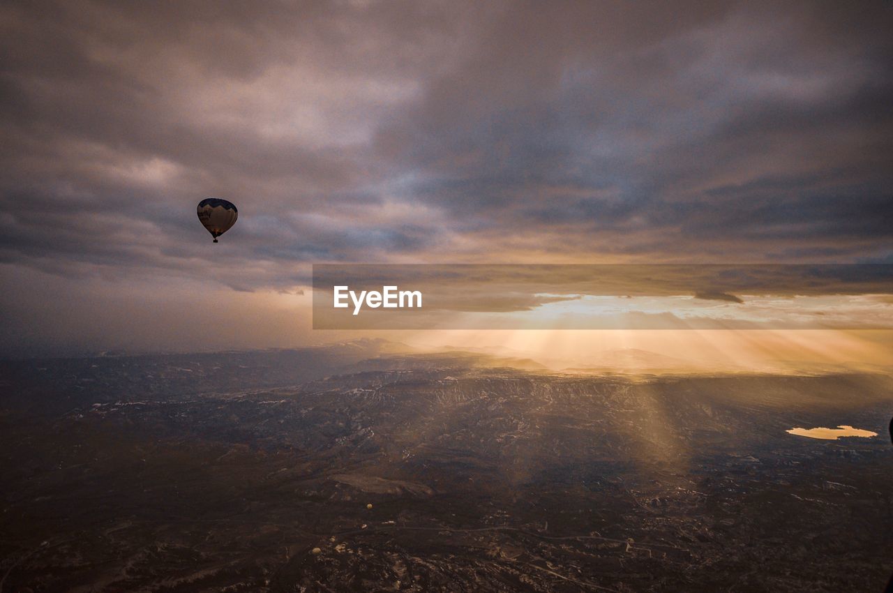 Hot air balloons flying against sky during sunset