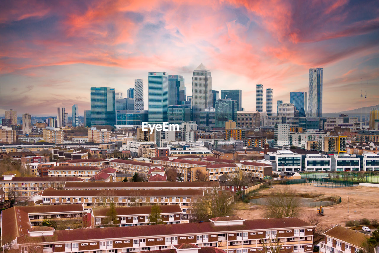 High angle view of buildings in canary wharf against sky during sunset