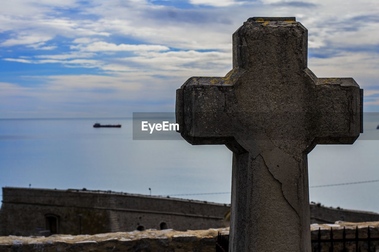 Close-up of cross against sky