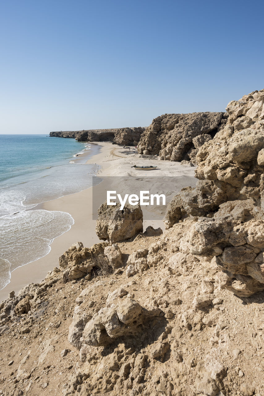 Wild beach at the coat of ras al jinz with copy space in the blue sky, sultanate of oman.