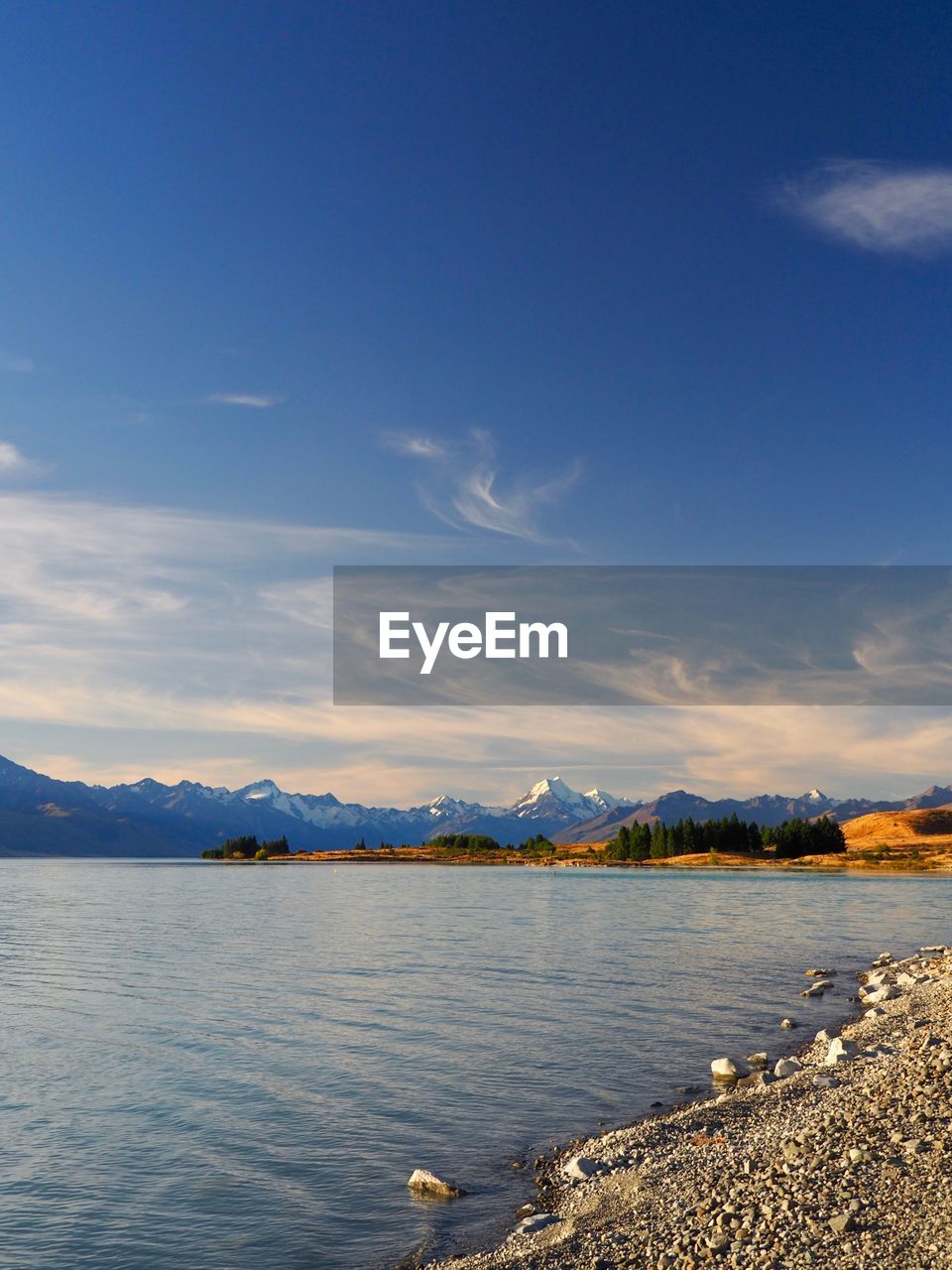 Scenic view of lake against blue sky