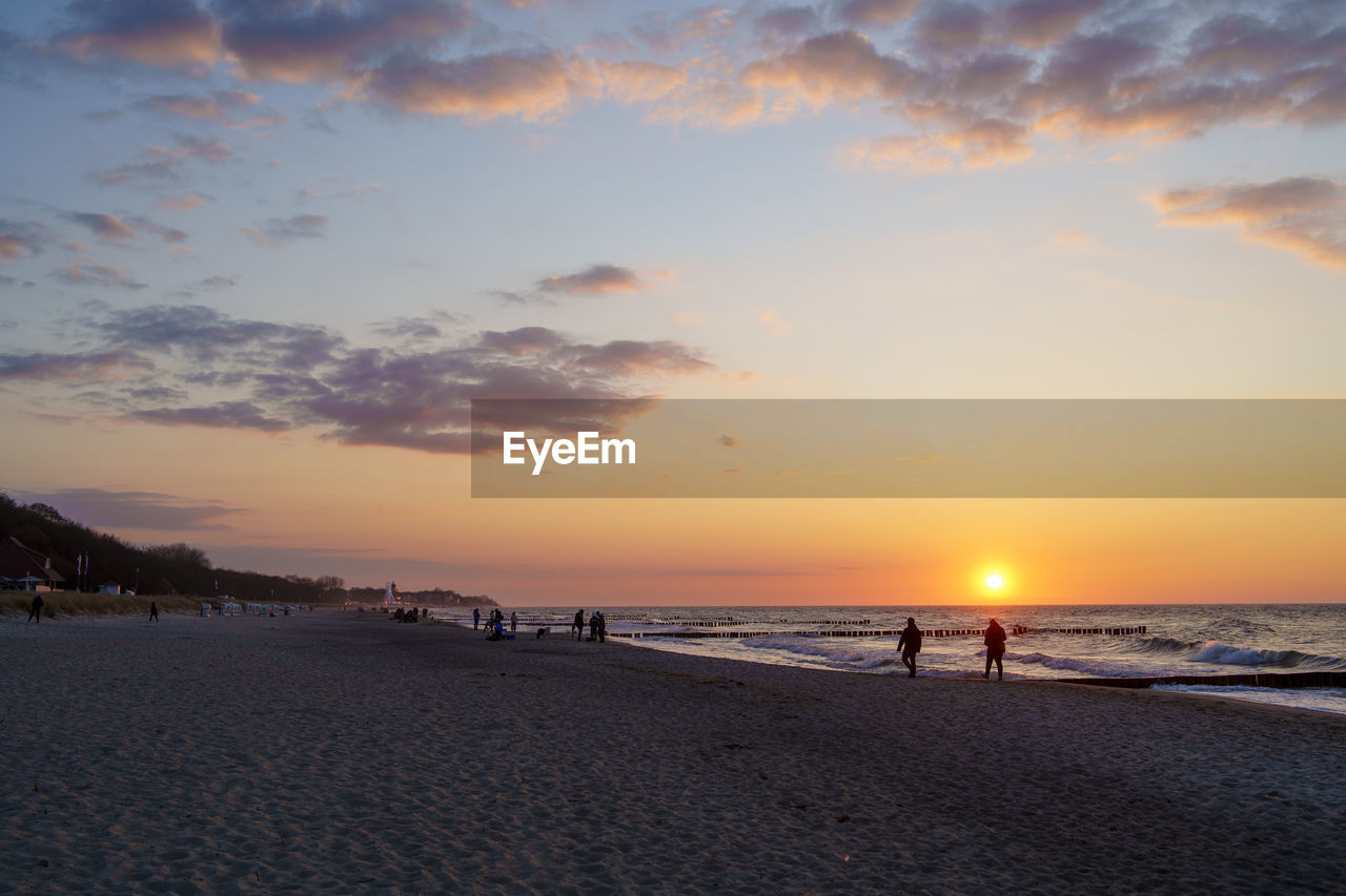 sky, sea, beach, sunset, water, land, beauty in nature, scenics - nature, horizon, nature, cloud, horizon over water, ocean, body of water, tranquility, sand, tranquil scene, shore, dawn, sunlight, sun, coast, orange color, idyllic, wave, holiday, evening, travel destinations, vacation, trip, afterglow, outdoors, silhouette, travel, dramatic sky, tourism, non-urban scene, coastline, wind wave, leisure activity, seascape, motion