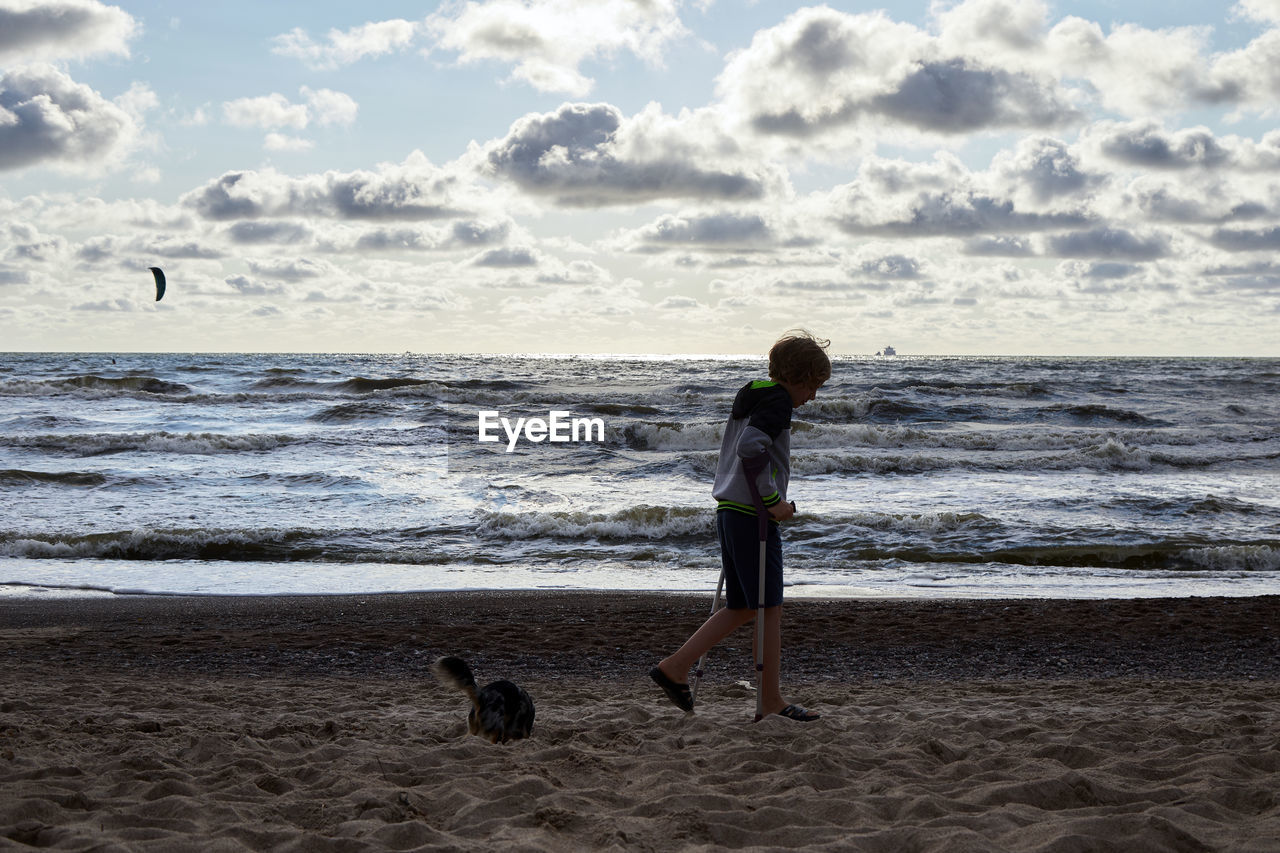 MAN AND DOG ON BEACH