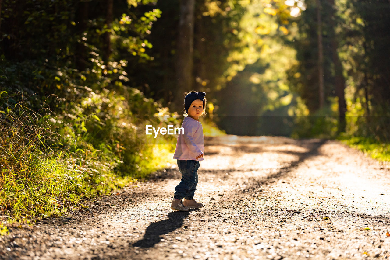 Portrait of girl standing on road