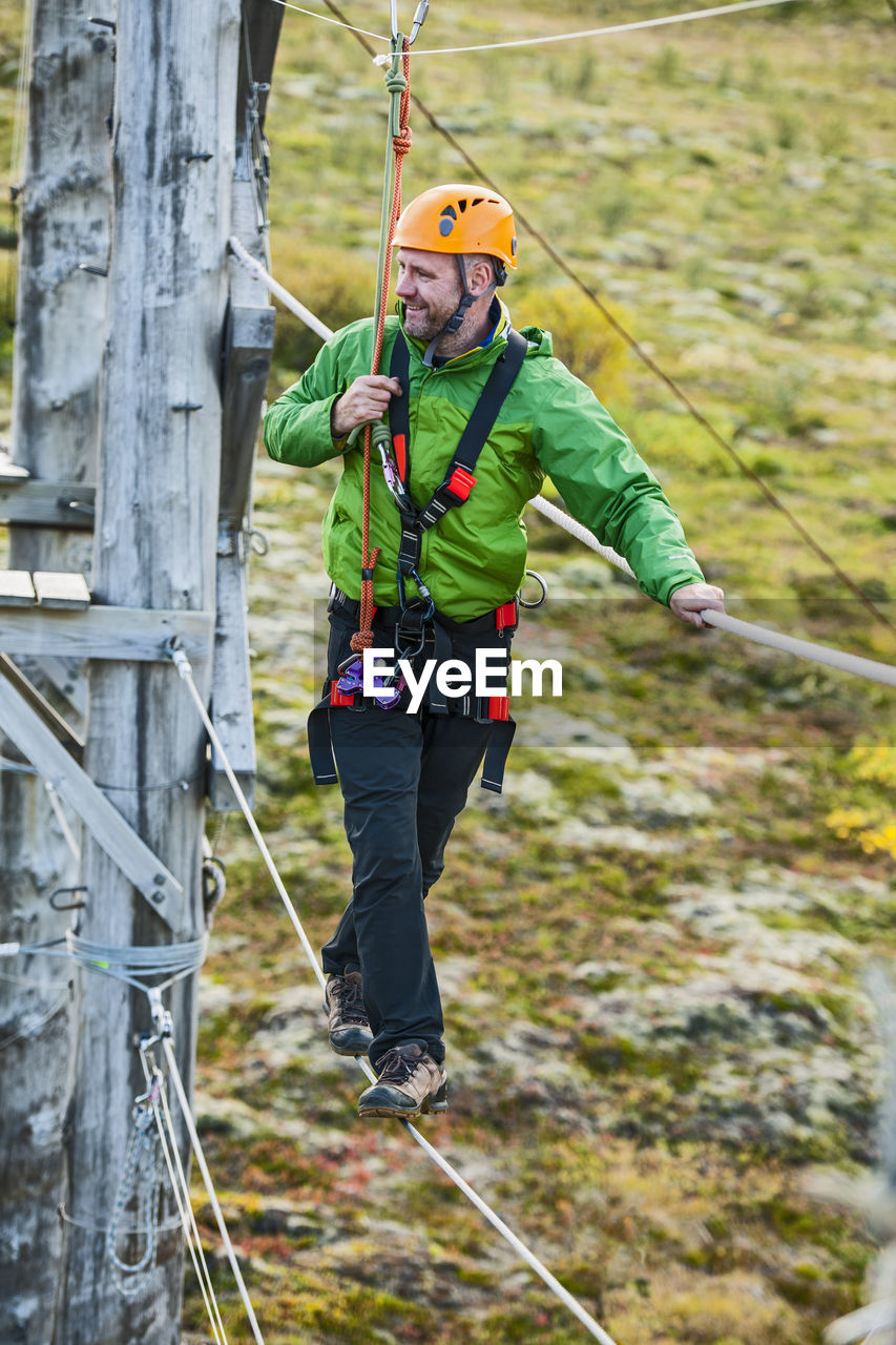 Man balancing on high rope obstacle course in iceland