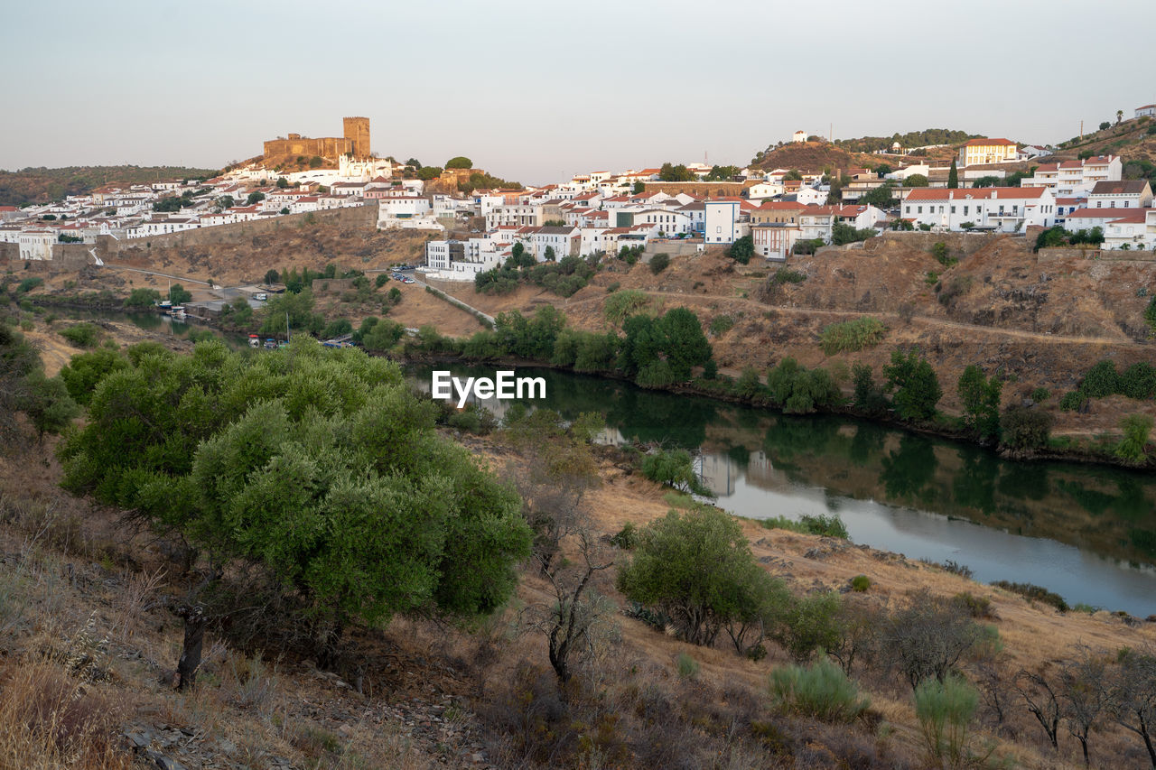 View of the alentejo town of mértola with the guadiana river in evidence.