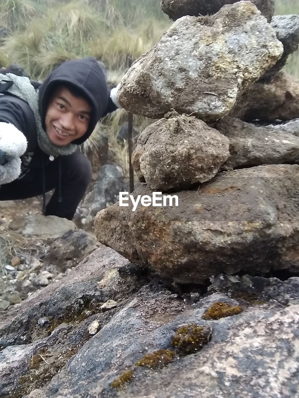 HIGH ANGLE PORTRAIT OF WOMAN ON ROCKS