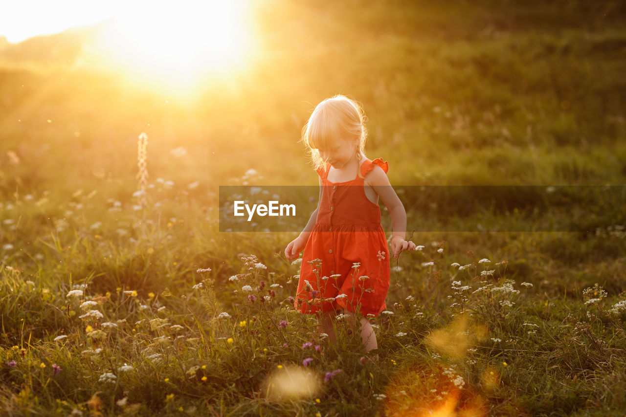 FULL LENGTH OF CHILD ON FIELD DURING RAINY SEASON