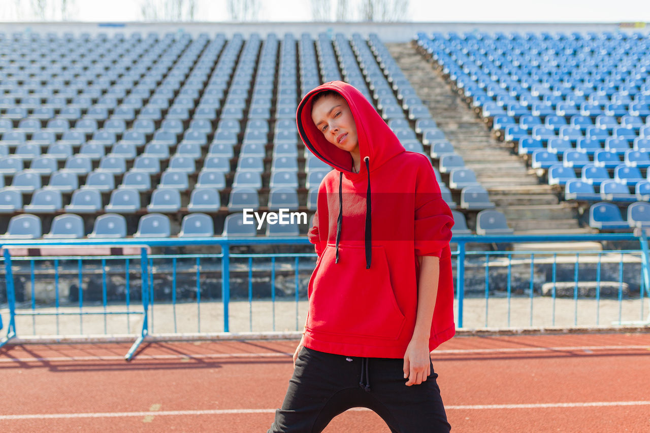 Portrait of woman standing in stadium