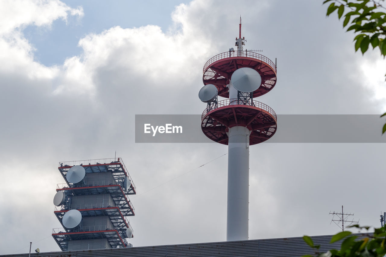 Low angle view of communications tower against sky