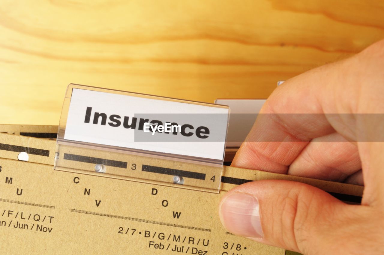 cropped hand of man holding paper