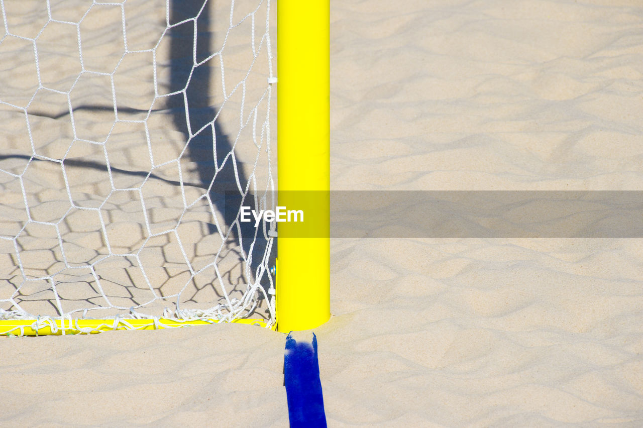 HIGH ANGLE VIEW OF YELLOW UMBRELLA