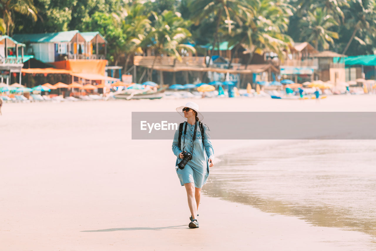 full length of woman walking on beach