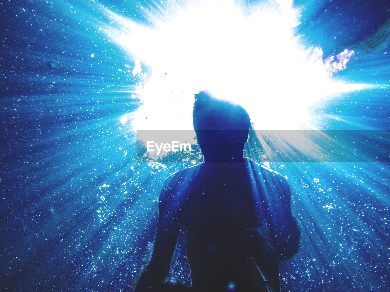 REAR VIEW OF MAN IN SEA