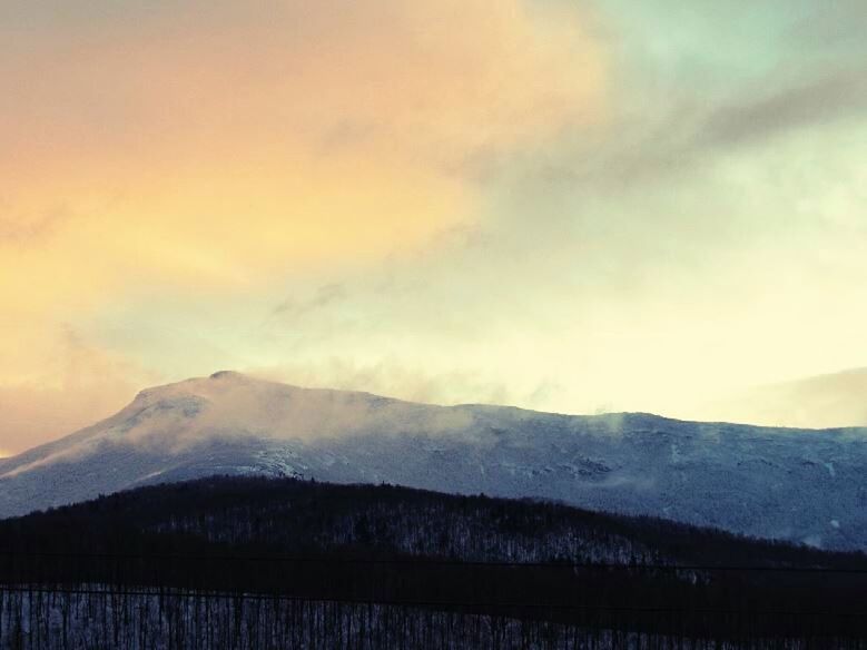 SNOW COVERED MOUNTAINS AGAINST SKY