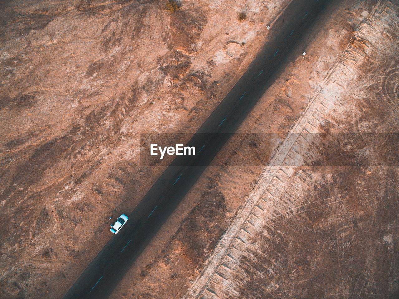 Aerial view of car on road amidst arid landscape