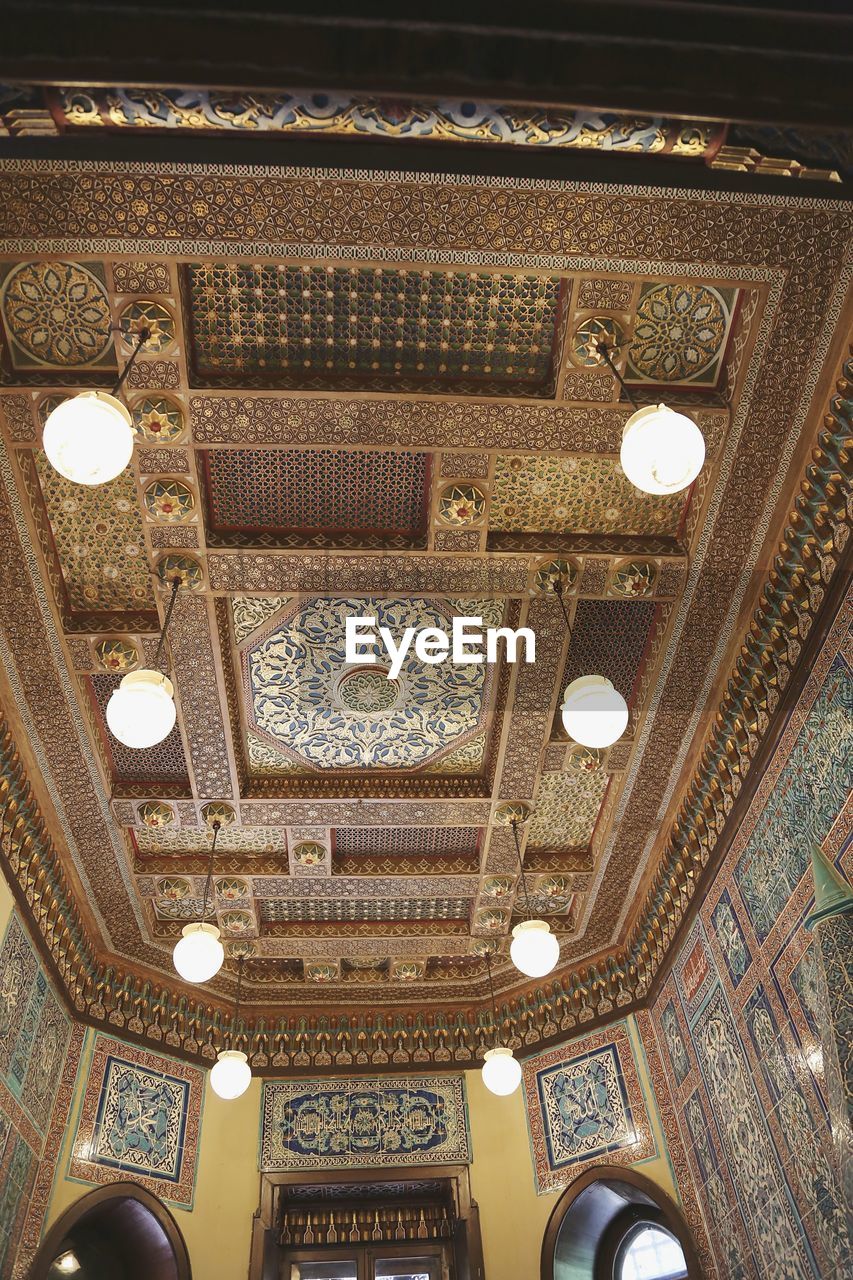 LOW ANGLE VIEW OF ILLUMINATED CEILING OF BUILDING