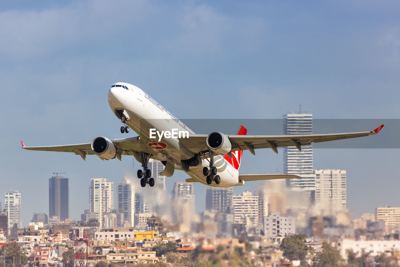 LOW ANGLE VIEW OF AIRPLANE AGAINST SKY