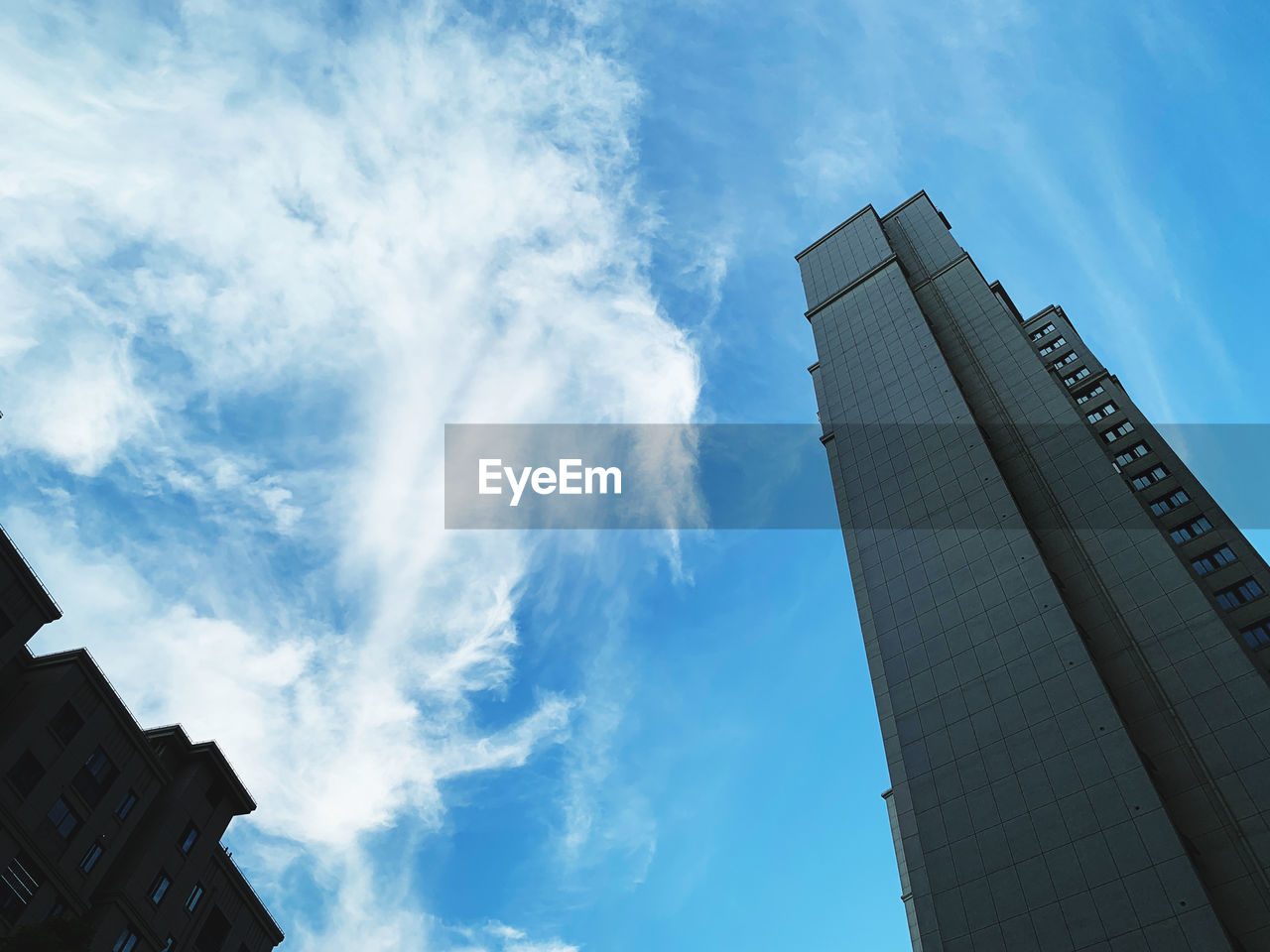 sky, blue, architecture, building exterior, built structure, skyscraper, cloud, building, city, low angle view, nature, office building exterior, sunlight, no people, office, reflection, tower block, tower, business, outdoors, day, daytime, finance, residential district