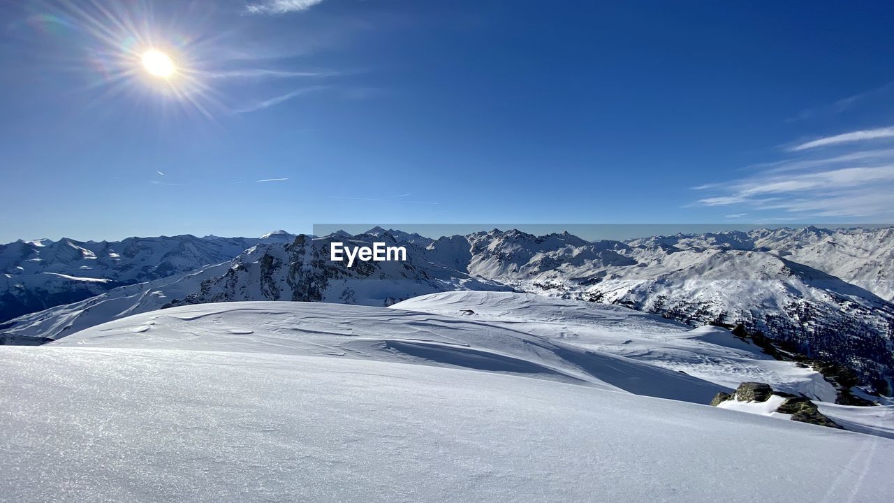 Scenic view of snow covered mountains against sky