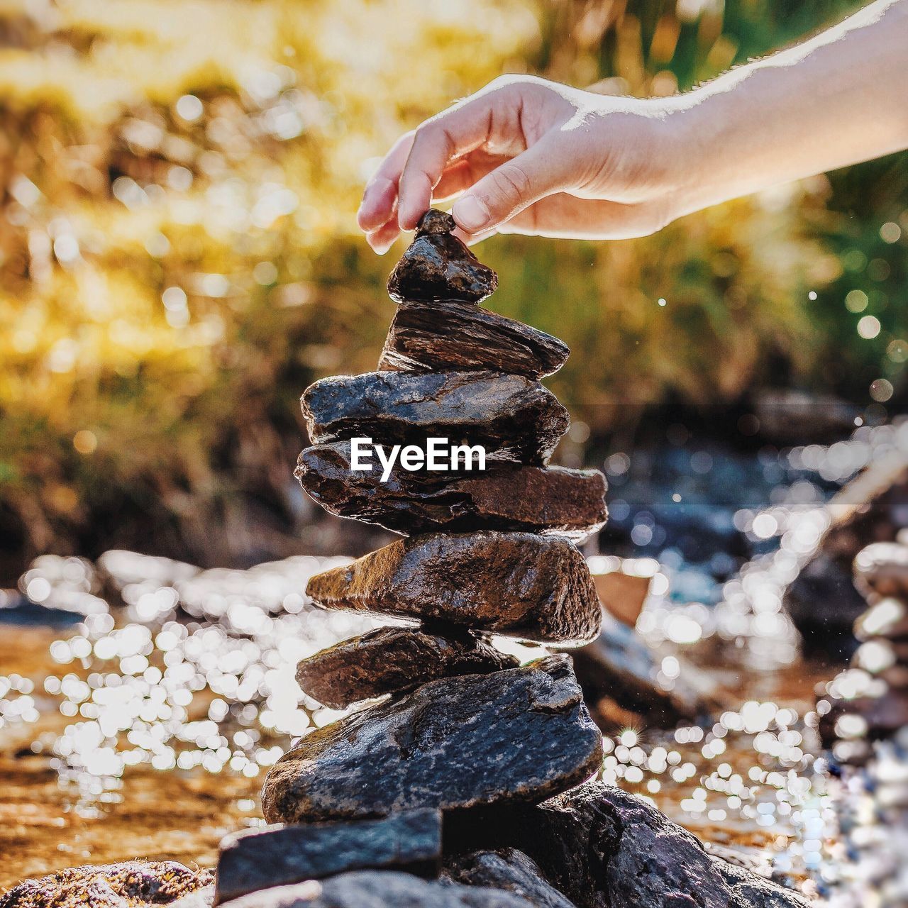 Close-up of person stacking rocks