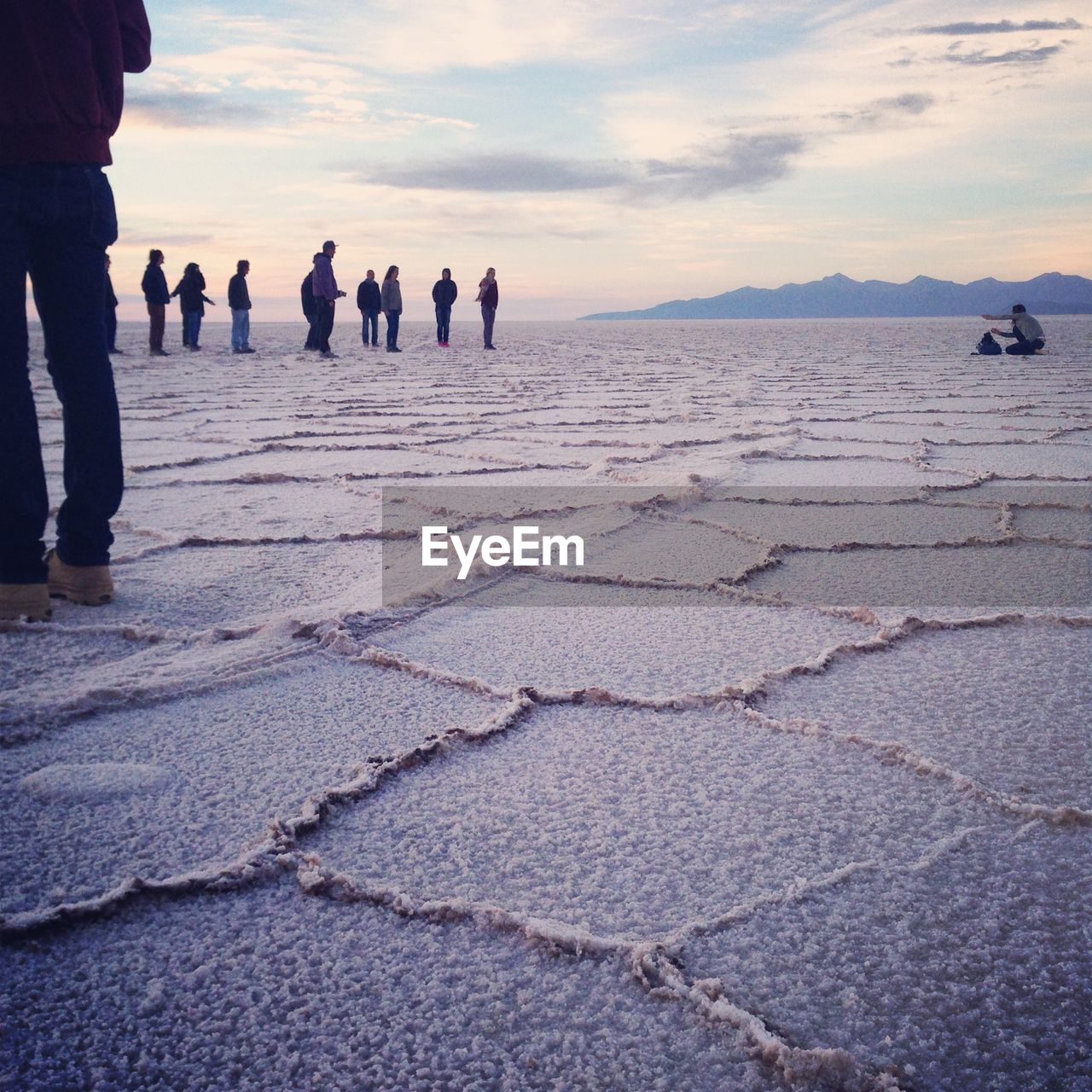 People at salar de uyuni against sky