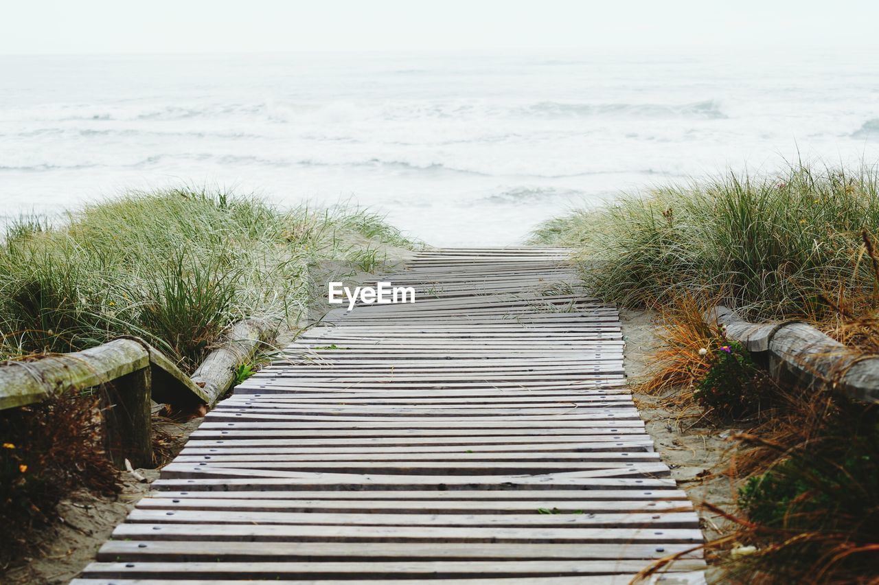 Wooden boardwalk leading to sea