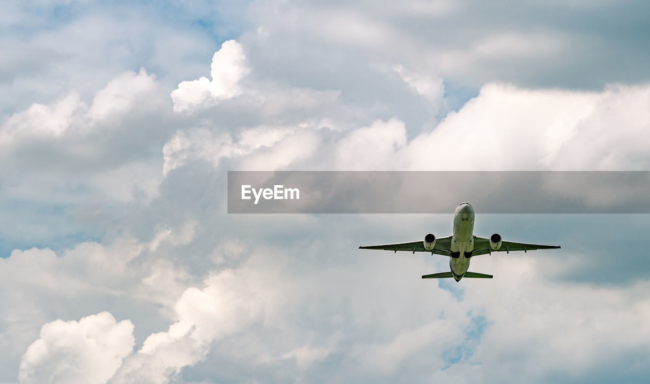 Airplane flying on sky and white fluffy cloud. commercial airline. aviation business crisis.