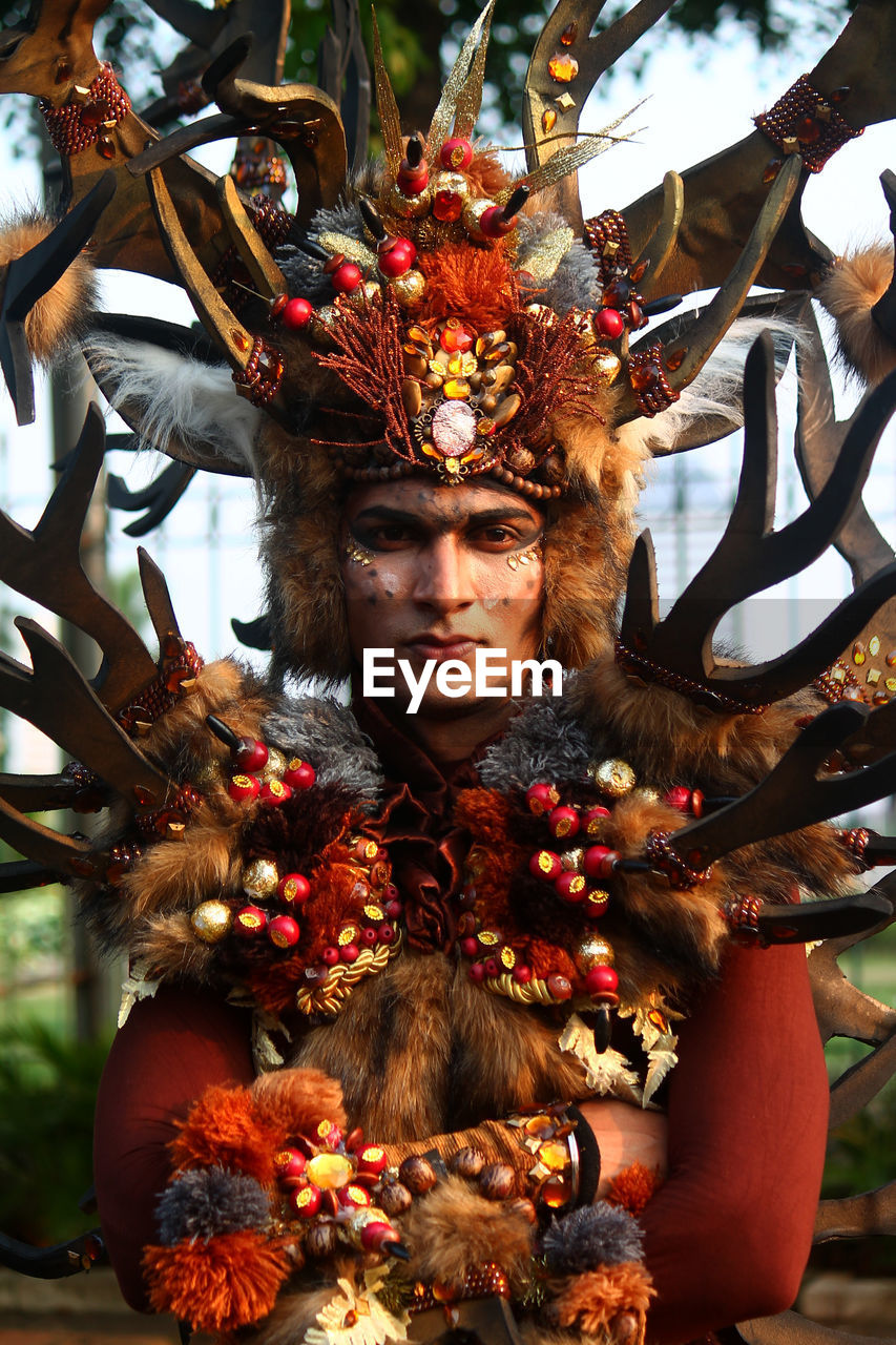 Portrait of man wearing face paint and costume at event