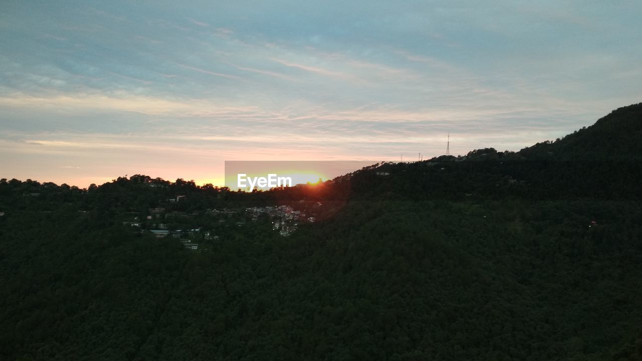 SCENIC VIEW OF SILHOUETTE LANDSCAPE AGAINST SKY AT SUNSET