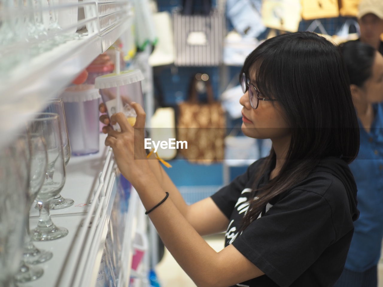 Side view of woman shopping at supermarket