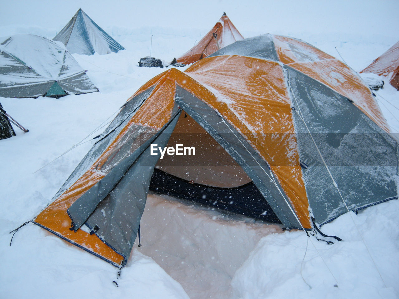 Returning home to mountaineering tent at denali basecamp in snowstorm on kahiltna glacier, alaska