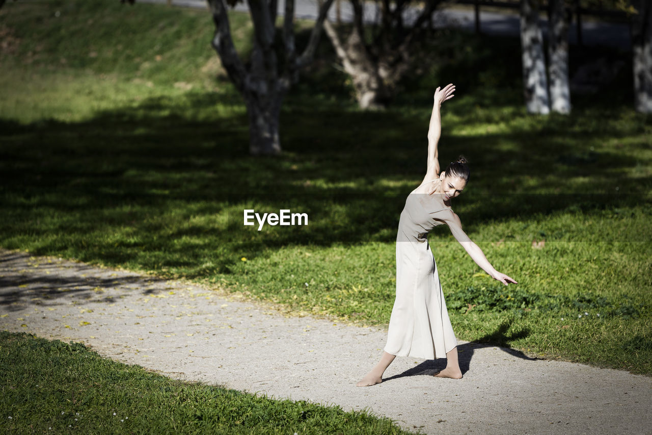 Full length of woman dancing at park