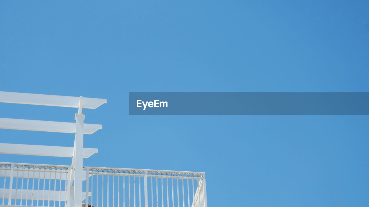 Low angle view of built structure against clear blue sky