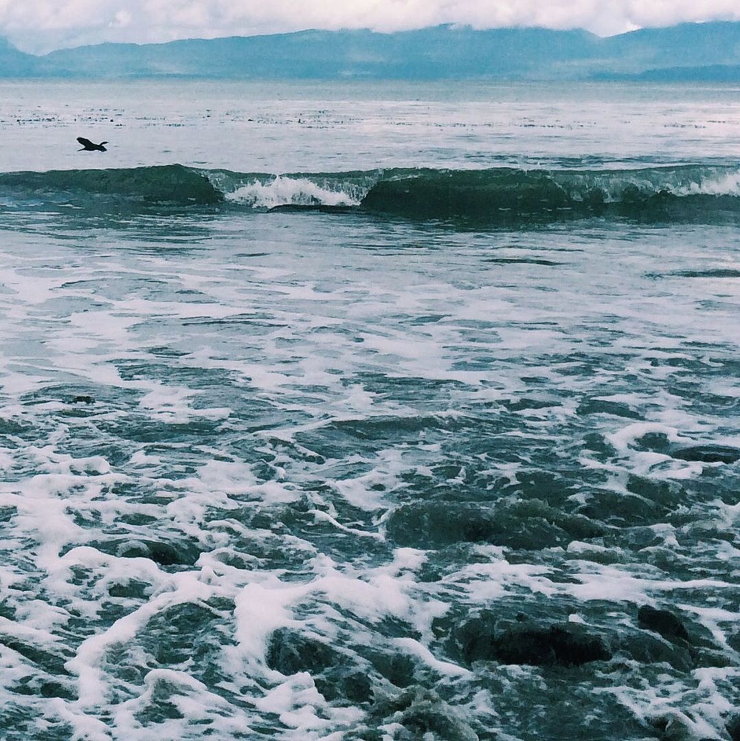 Scenic view of sea against mountain