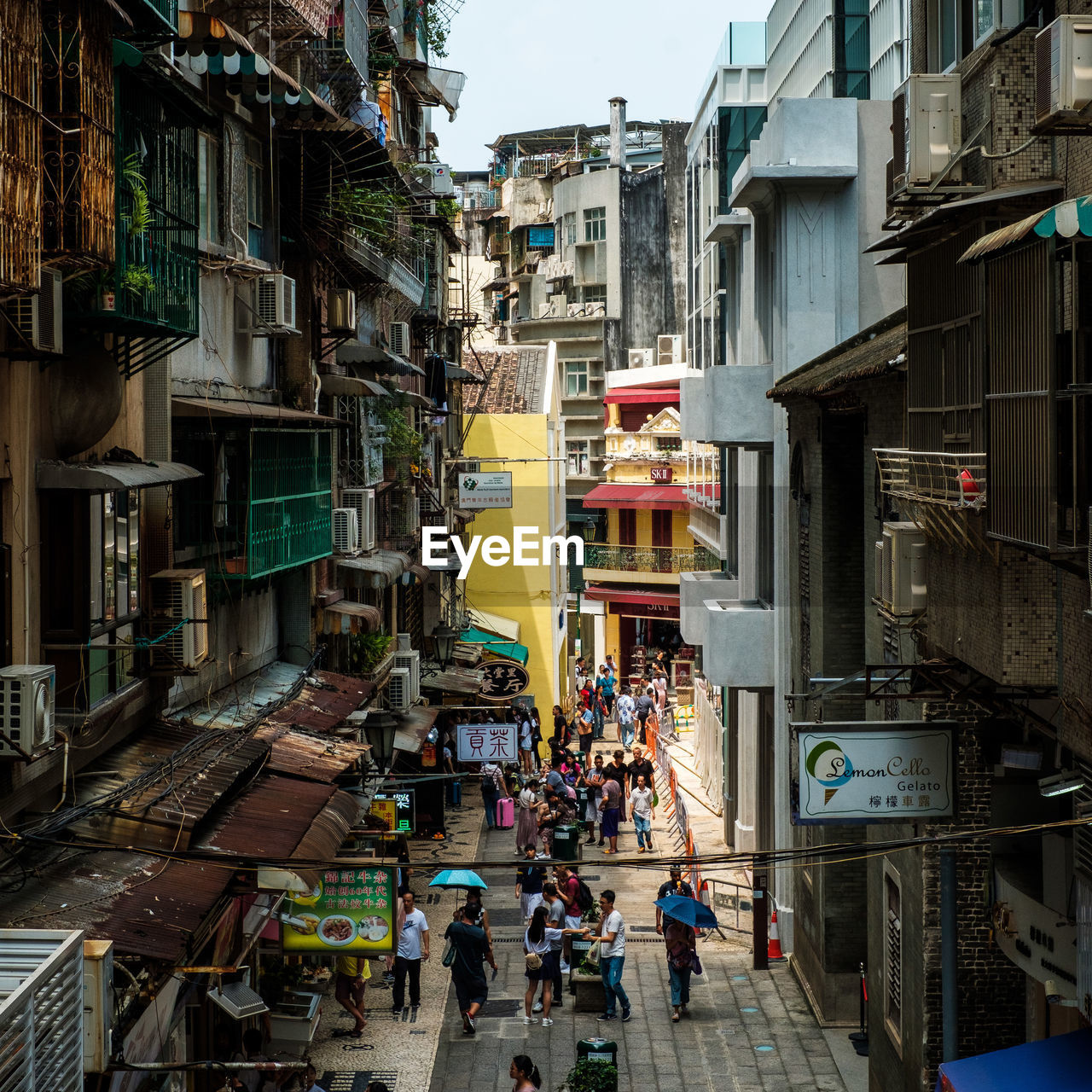 PEOPLE WALKING ON STREET IN CITY