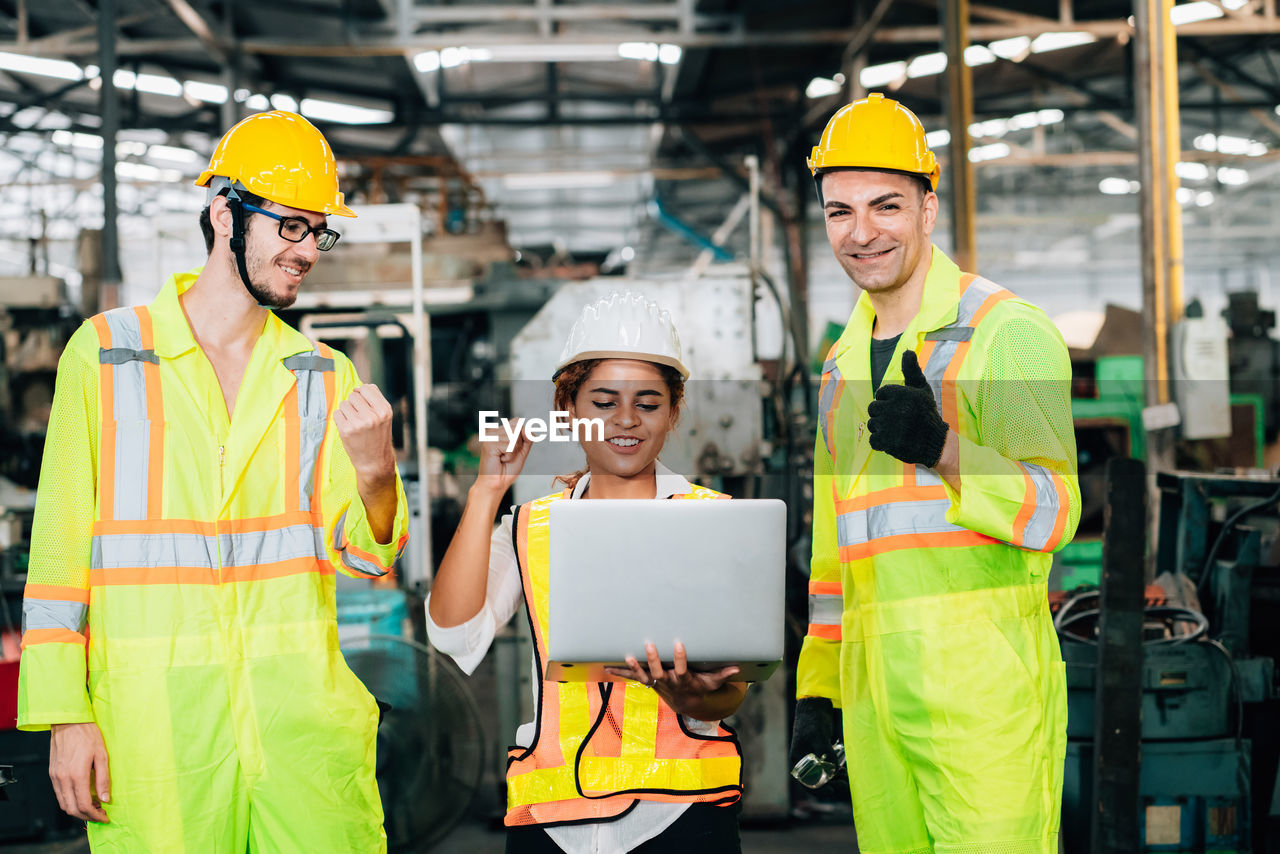 Cheerful engineers working at factory