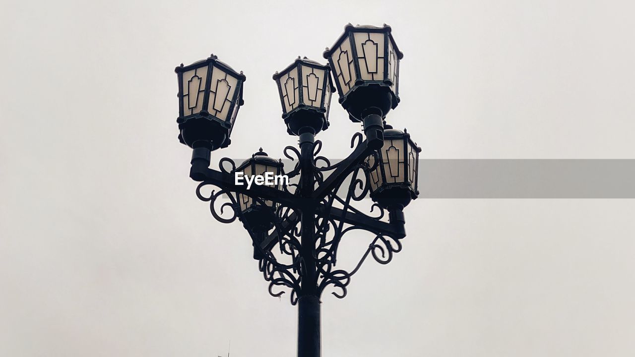 Low angle view of street lights against sky