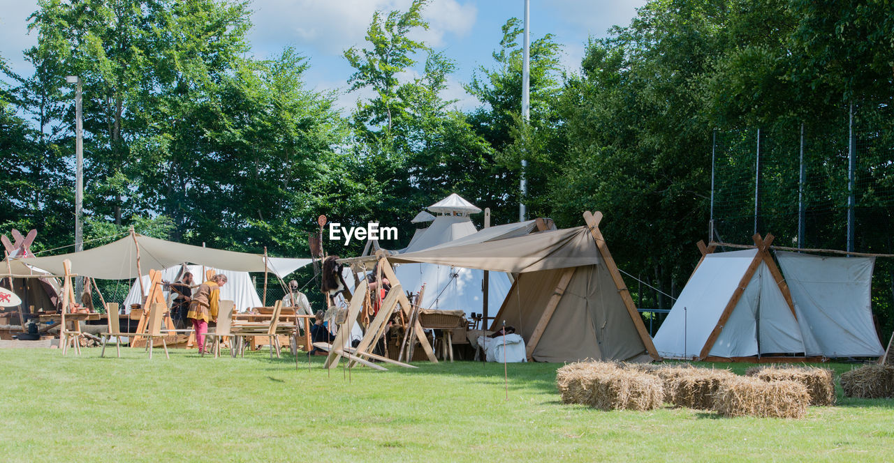 Tents on field against trees