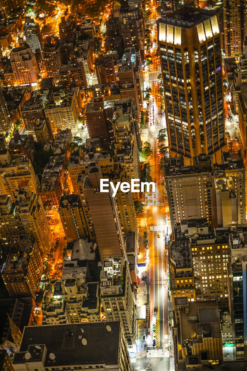 HIGH ANGLE VIEW OF ILLUMINATED CITY BUILDINGS