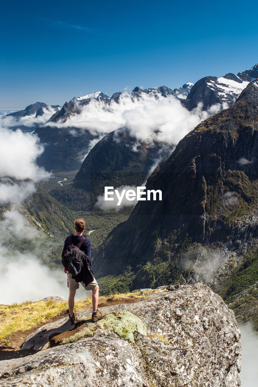 Rear view of man of man hiking in fiordland national park