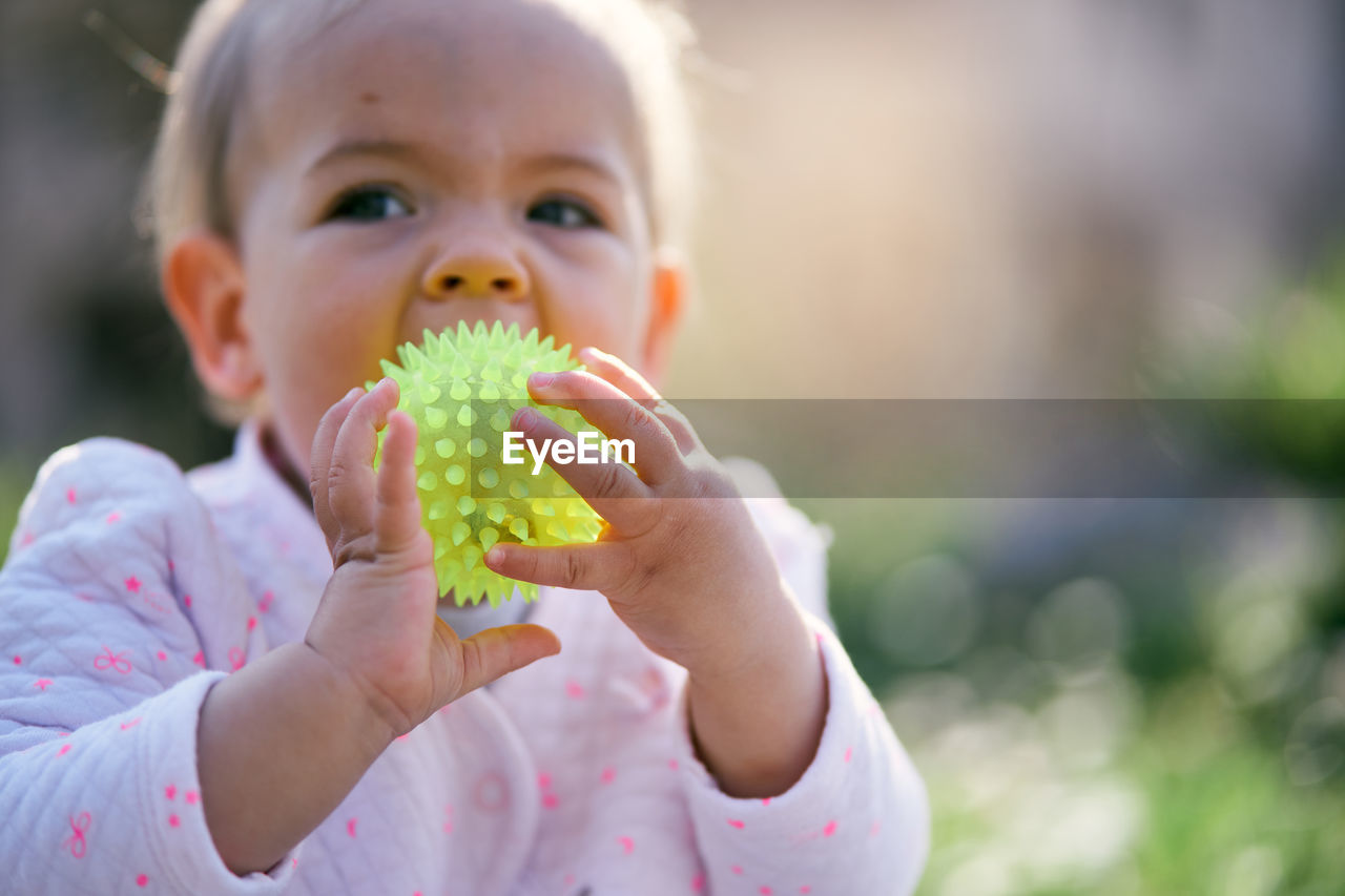 Close-up of cute girl playing outdoors