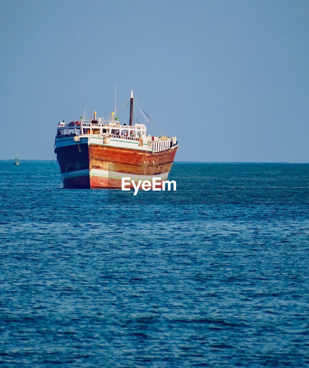 SHIP SAILING ON SEA AGAINST CLEAR SKY