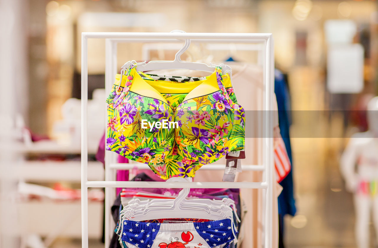 Close-up of multi colored clothes hanging at store